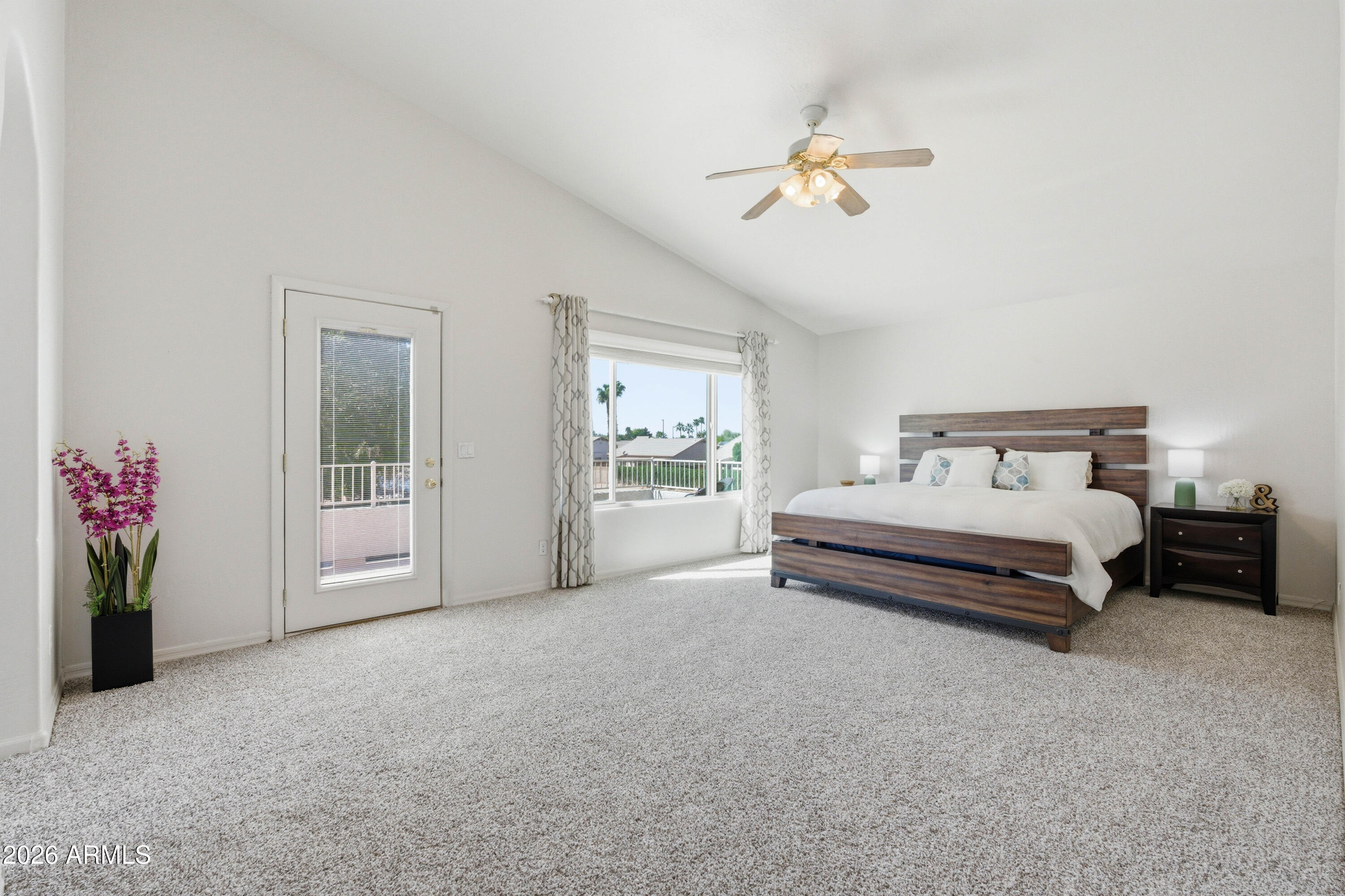 418 South Burk Street Gilbert, AZ 85296 - Photo 7 of 90 a spacious bedroom with a bed and a chandelier