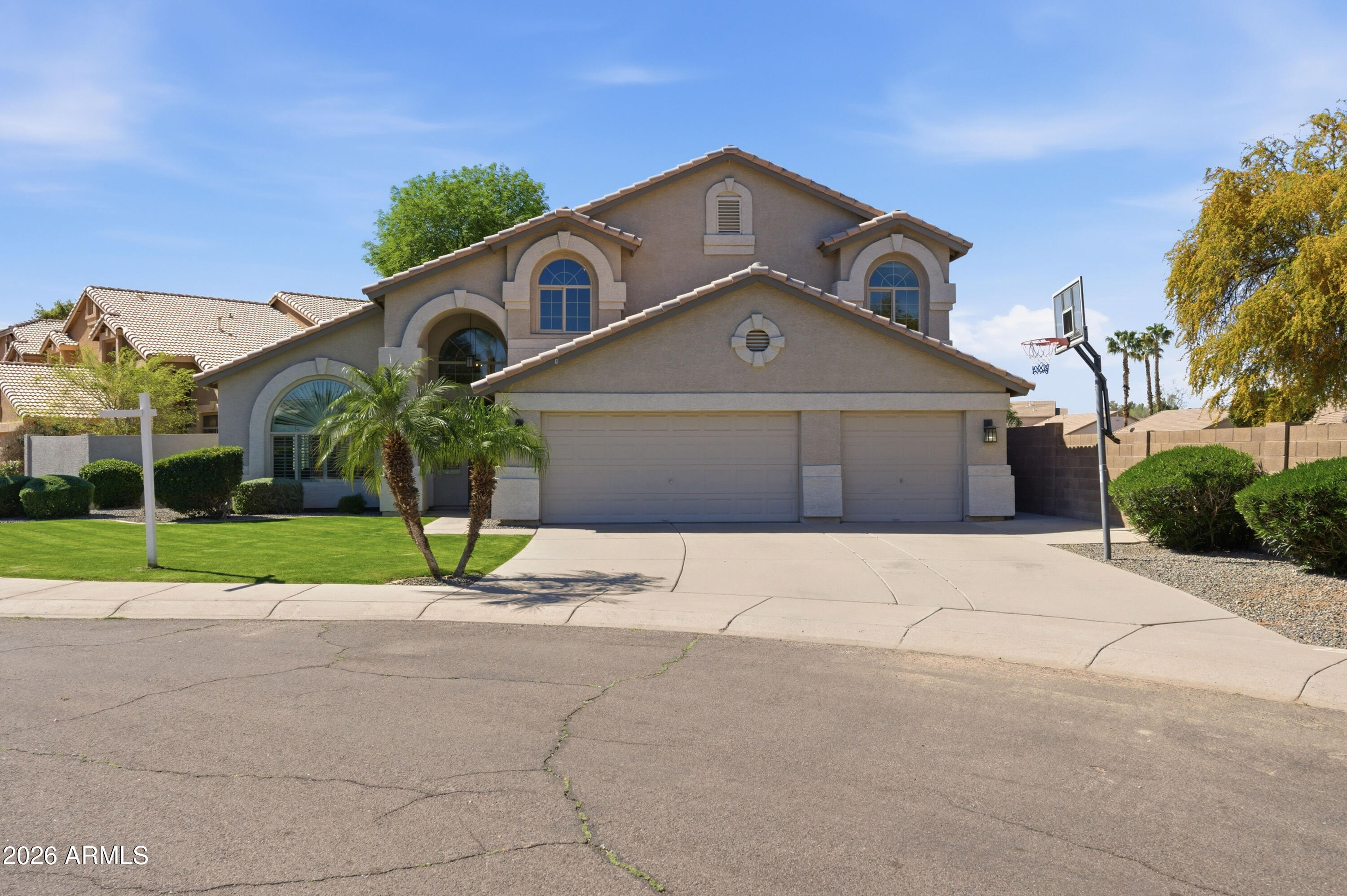 418 South Burk Street Gilbert, AZ 85296 - Photo 8 of 90 a front view of a house with a yard and garage