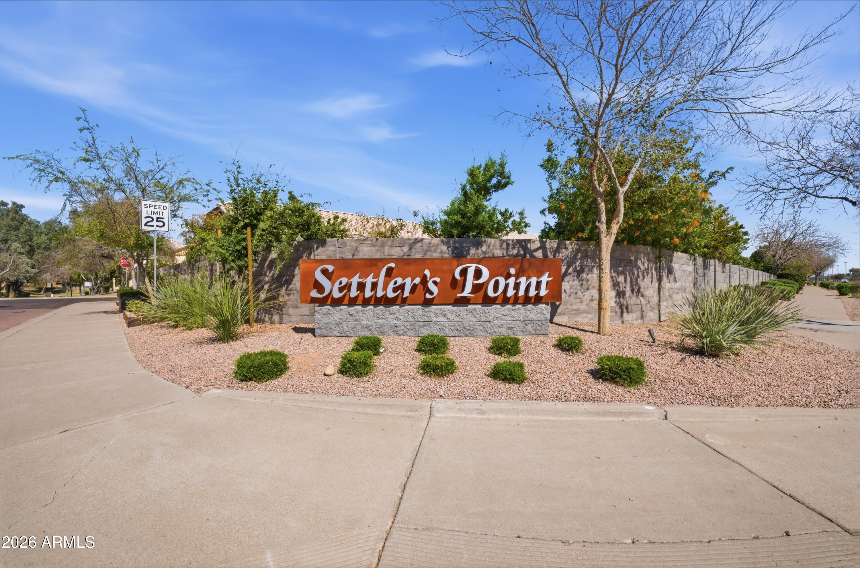 418 South Burk Street Gilbert, AZ 85296 - Photo 81 of 90 a view of a sign board with flower plants and wooden fence