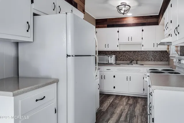 a kitchen with a refrigerator and a stove