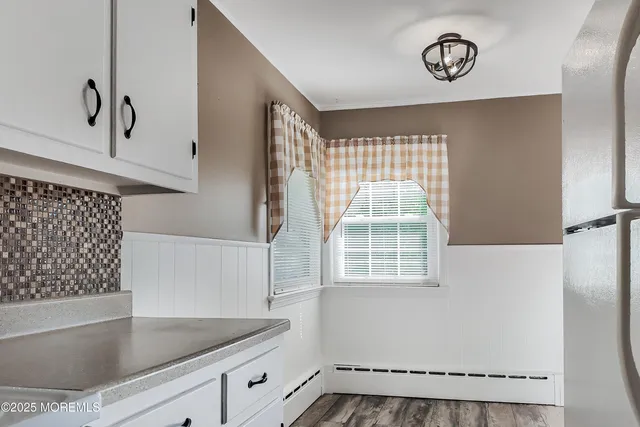 a view of a kitchen with a fridge and a window