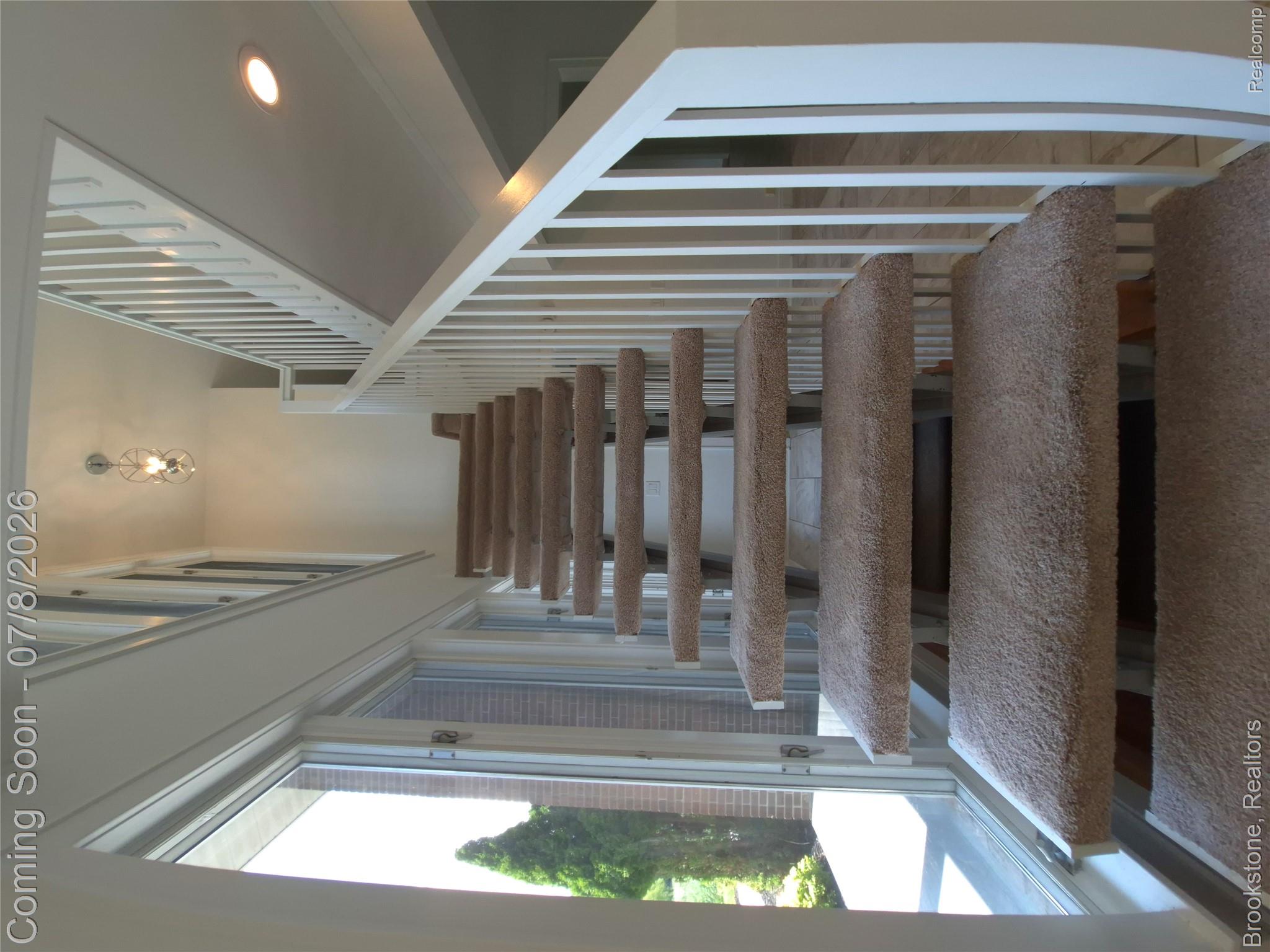 4140 South Henderson Road Davison, MI 48423 - Photo 35 of 98 Carpeted staircase with white balusters and handrail