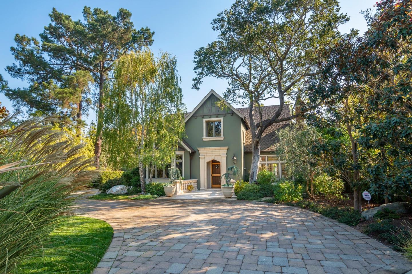 a front view of a house with yard and green space