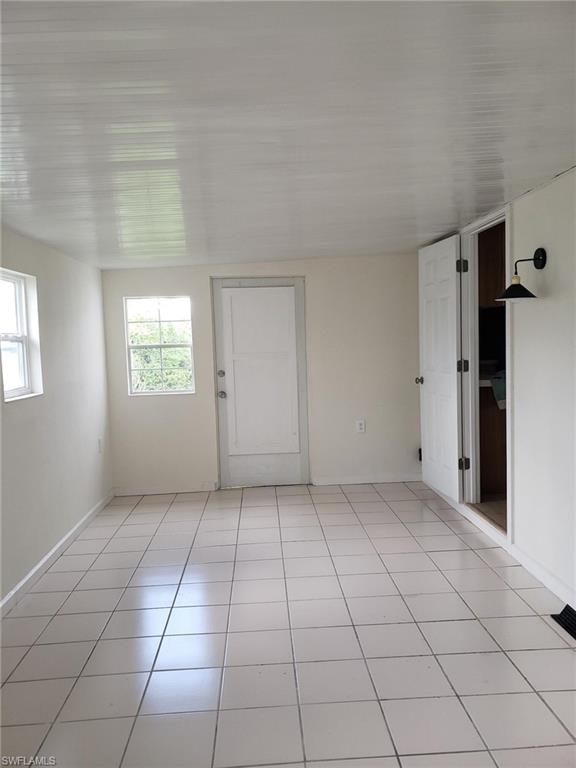 11 Muleshoe Trail, Unit 253 Naples, FL 34113 - Photo 7 of 9 an empty room with windows
