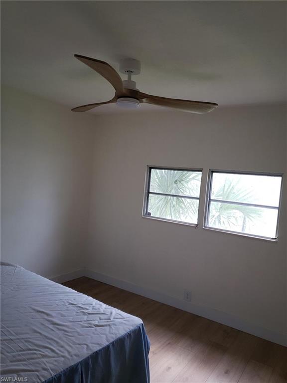 11 Muleshoe Trail, Unit 253 Naples, FL 34113 - Photo 9 of 9 a view of a room that has a window and wooden floor