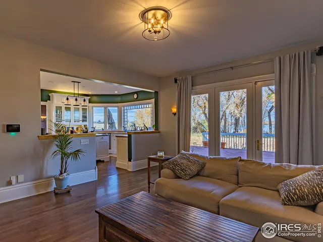a living room with furniture flat screen tv and wooden floor