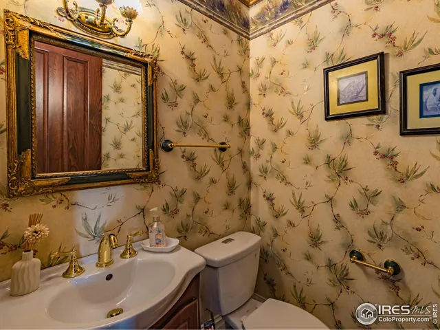 a bathroom with a granite countertop sink a mirror a bathtub and shower