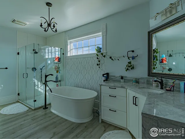 a bathroom with a tub shower and mirror