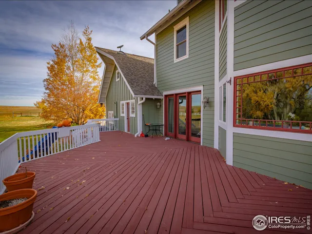 a view of a house with wooden deck