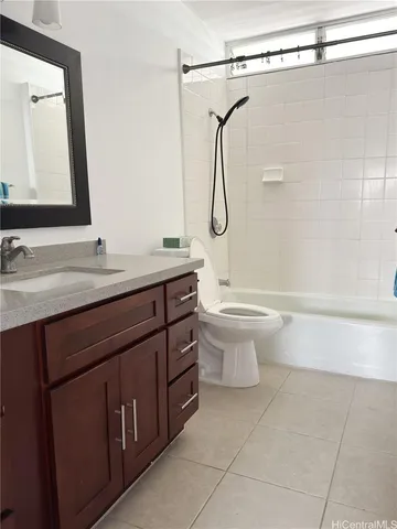 a bathroom with a granite countertop sink a toilet and a mirror