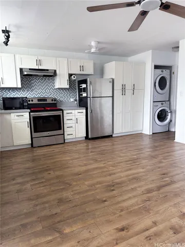 a kitchen with granite countertop a refrigerator and a stove