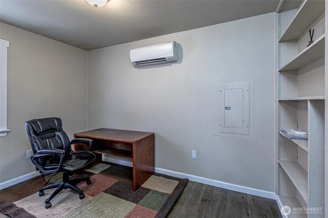 a view of workspace with wooden floor and a window
