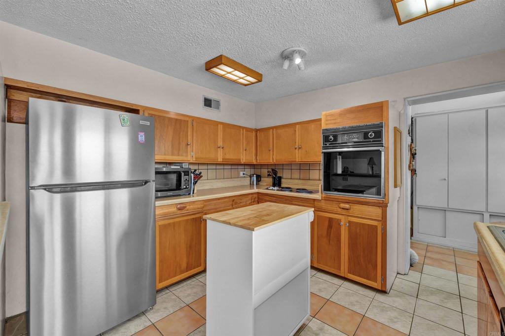 3245 Borrego Springs Road Borrego Springs, CA 92004 - Photo 7 of 25 a kitchen with stainless steel appliances granite countertop a refrigerator and a stove top oven