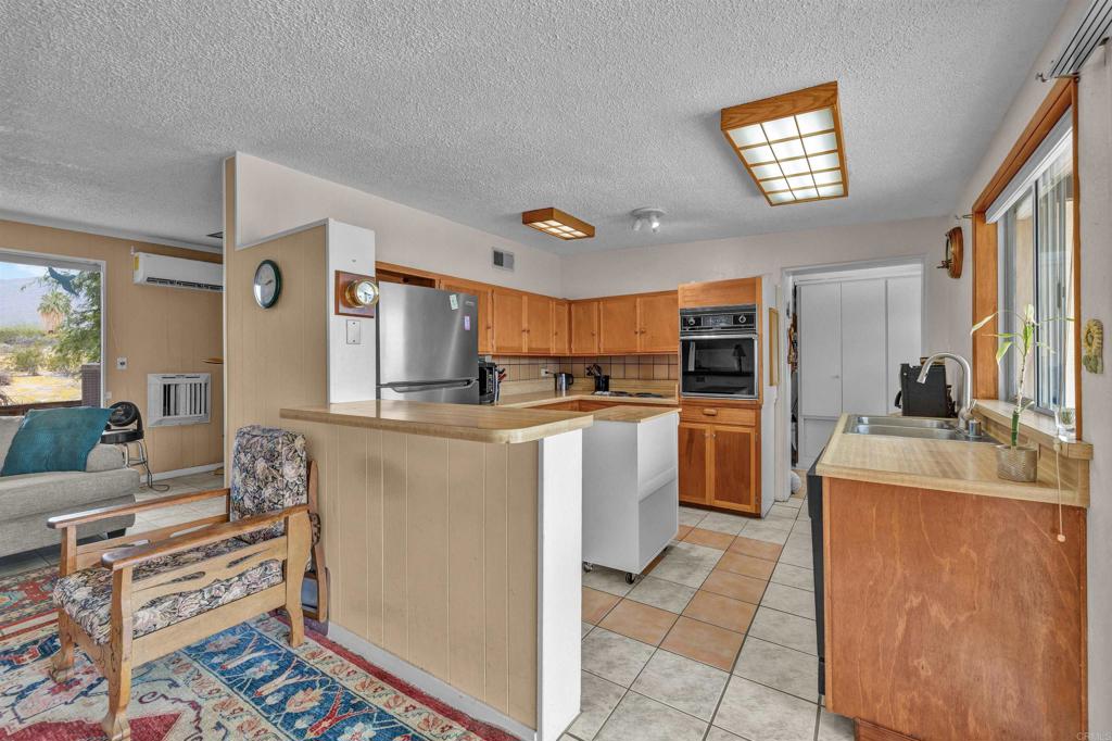 3245 Borrego Springs Road Borrego Springs, CA 92004 - Photo 8 of 25 a kitchen with cabinets and window