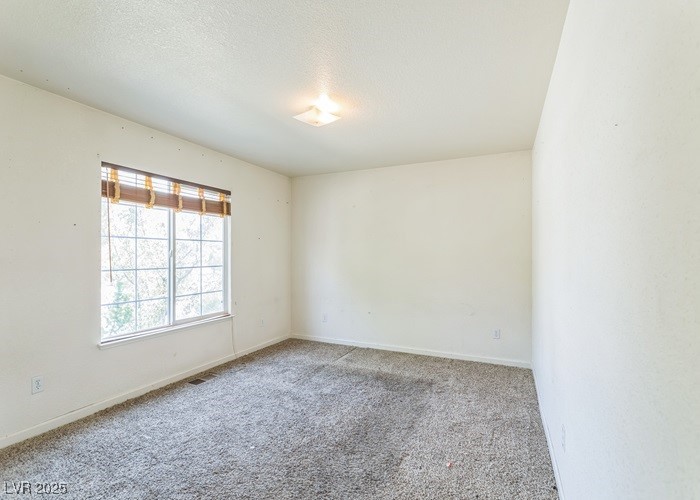 17710 Fairfax Court Reno, NV 89508 - Photo 6 of 19 Carpeted empty room featuring a textured ceiling and baseboards