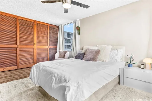 a bedroom with a large bed and a large window