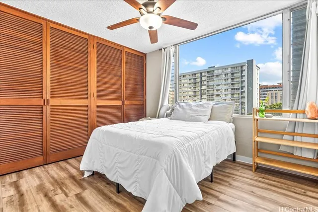 a bedroom with a large bed and a chandelier