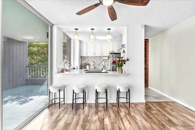 a view of dining room with stainless steel appliances granite countertop furniture and a kitchen view