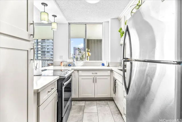 a kitchen with a sink a refrigerator and a stove