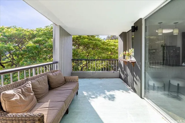 a balcony with furniture and a potted plant