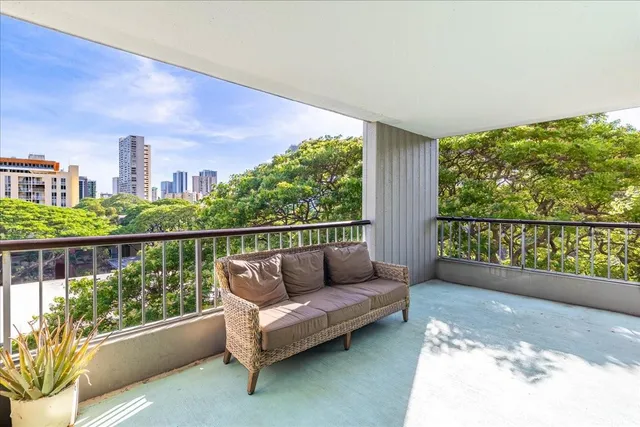 a balcony with furniture and a potted plant