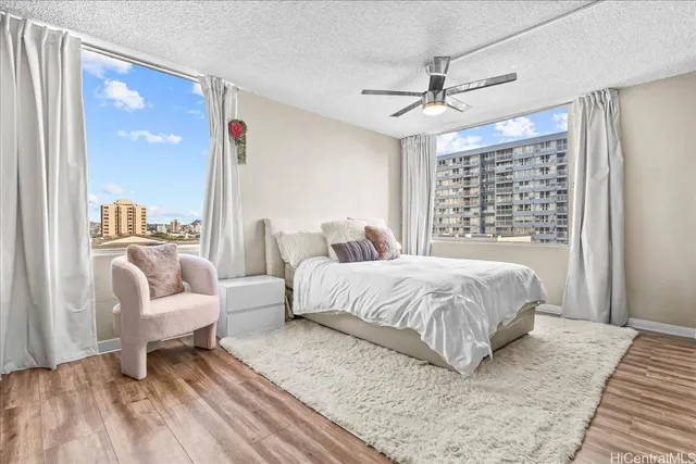 a spacious bedroom with a bed and glass walk in closet