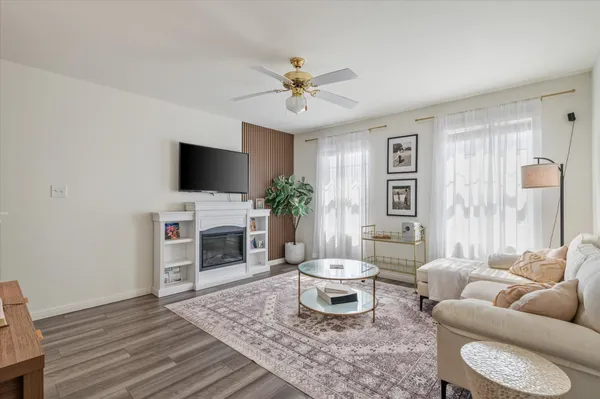 a living room with furniture and a potted plant