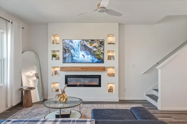 a living room with furniture a rug and a fireplace