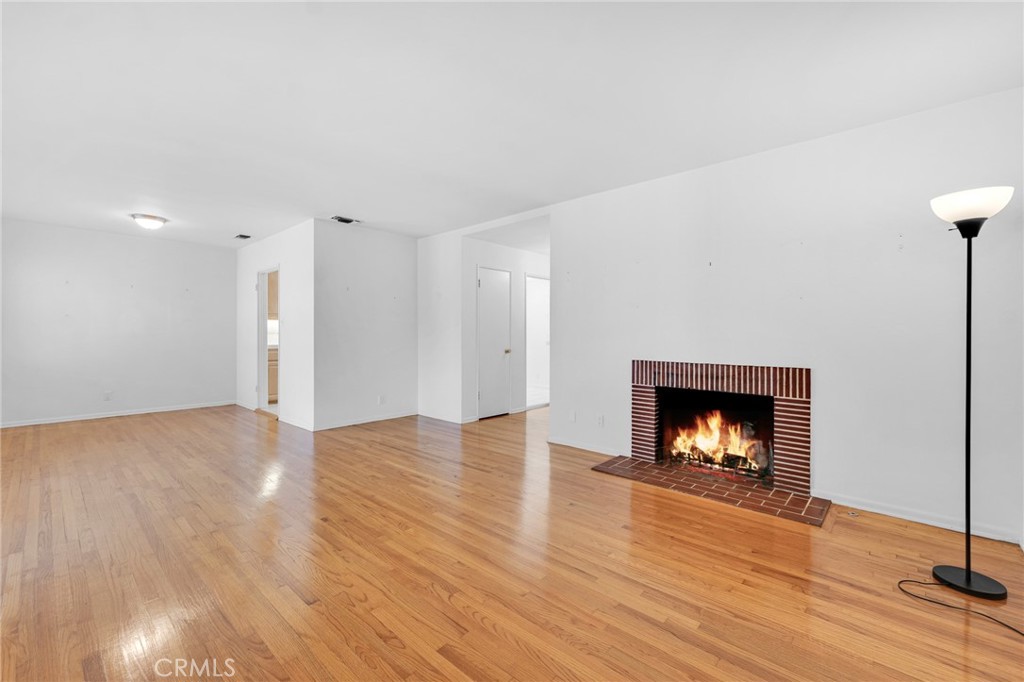 2107 Jolley Drive Burbank, CA 91504 - Photo 4 of 33 a view of an empty room with wooden floor fireplace and a window