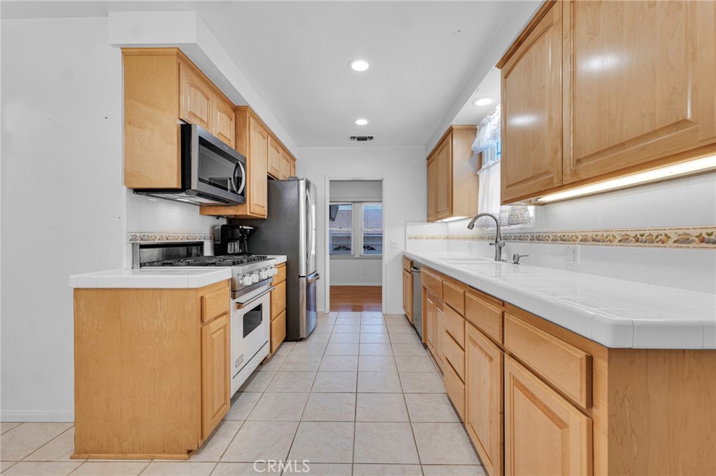 2107 Jolley Drive Burbank, CA 91504 - Photo 10 of 33 a large kitchen with stainless steel appliances granite countertop a lot of counter space and a sink
