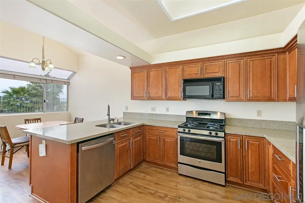 5064 Frazee Road Oceanside, CA 92057 - Photo 11 of 25 a kitchen with a sink stove and microwave
