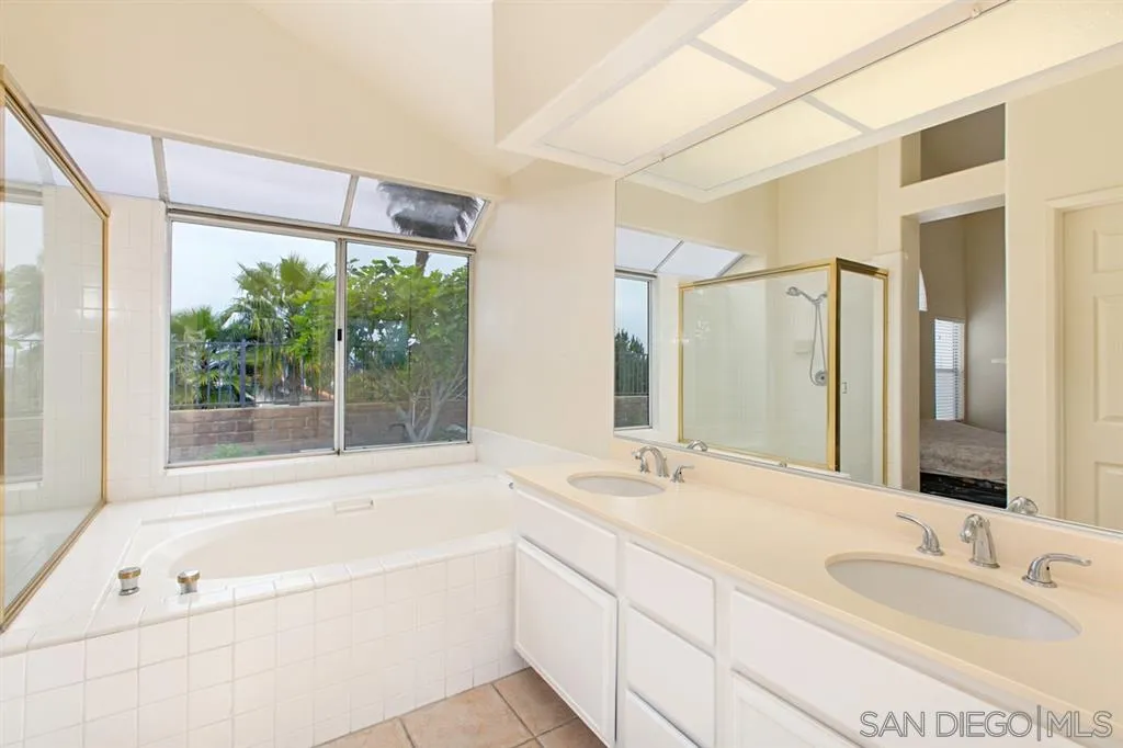 5064 Frazee Road Oceanside, CA 92057 - Photo 18 of 25 a bathroom with a tub a sink and a large window
