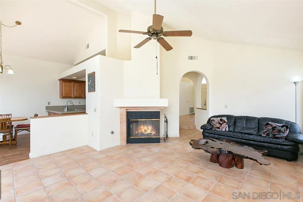 5064 Frazee Road Oceanside, CA 92057 - Photo 2 of 25 a living room with furniture a fireplace and a flat screen tv