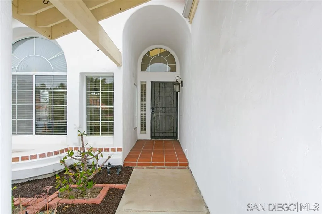 5064 Frazee Road Oceanside, CA 92057 - Photo 7 of 25 a view of a brick house with potted plants
