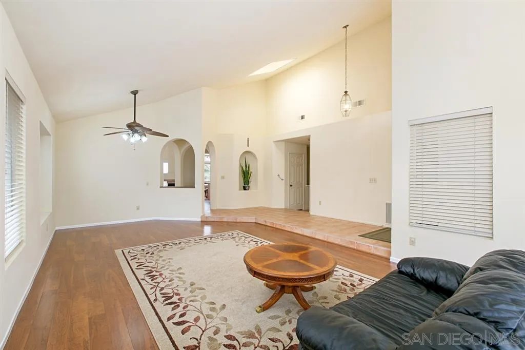 5064 Frazee Road Oceanside, CA 92057 - Photo 10 of 25 a living room with furniture and a wooden floor