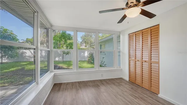 a view of room with window and wooden floor