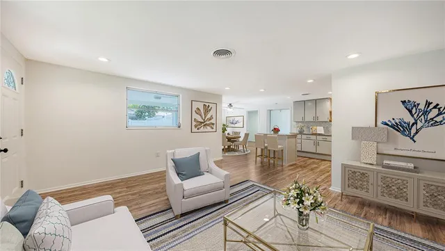 a living room with furniture and wooden floor