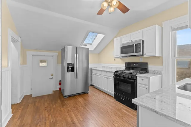 a kitchen with stainless steel appliances granite countertop a stove and a refrigerator