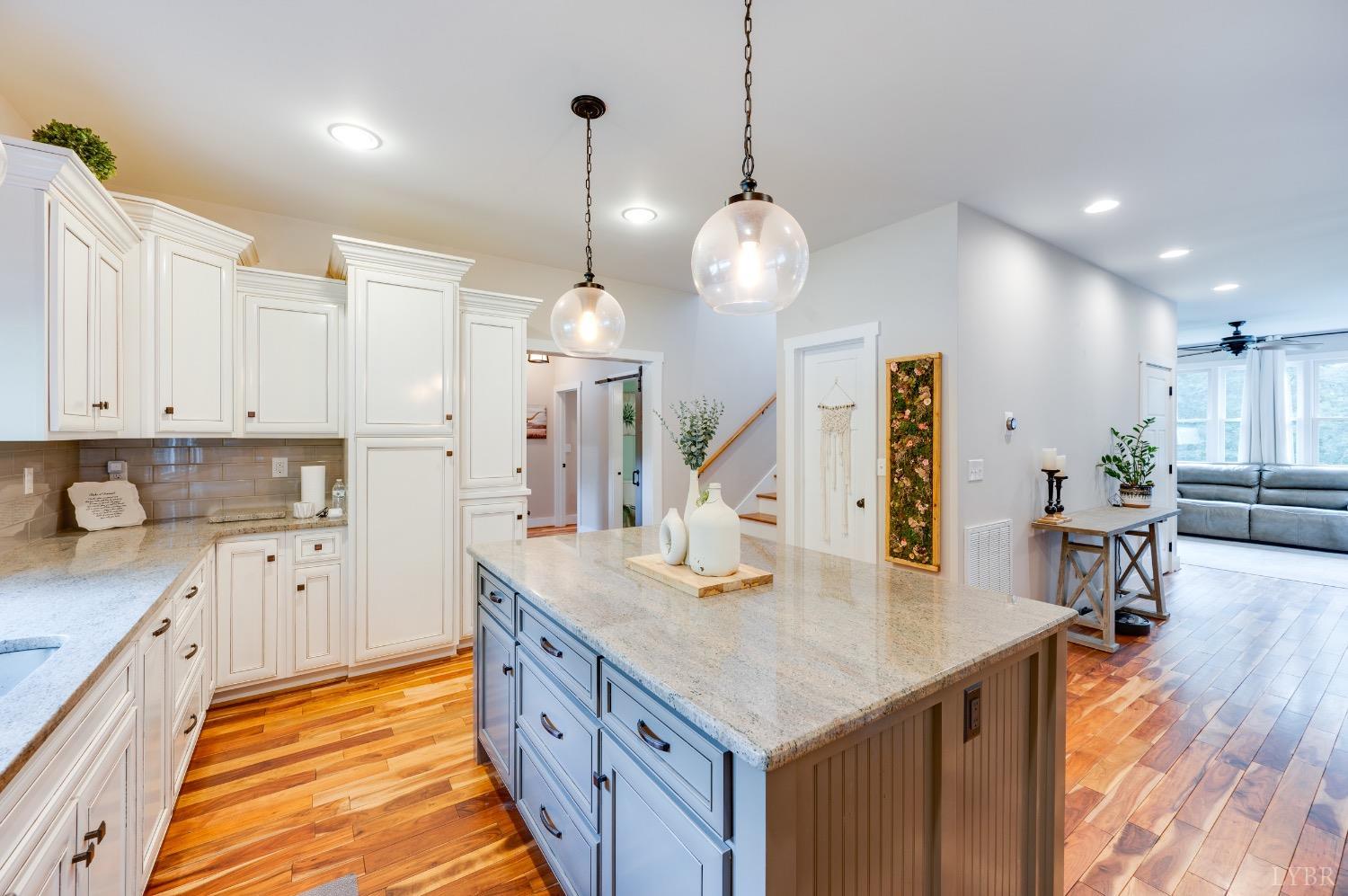 2842 Chilton Road Appomattox, VA 24522 - Photo 8 of 75 a kitchen with stainless steel appliances kitchen island granite countertop a sink a stove and a wooden floors