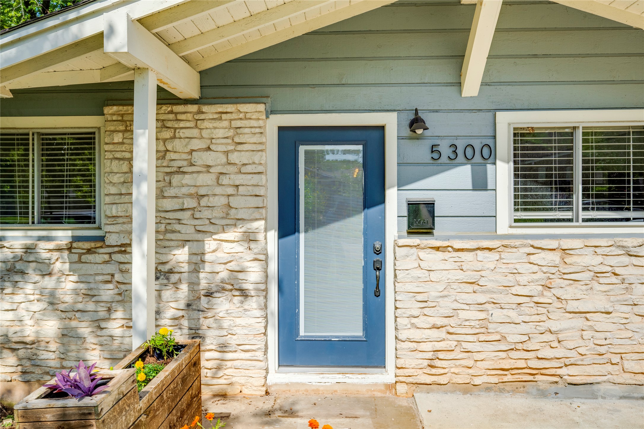 5300 Halmark Drive Austin, TX 78723 - Photo 4 of 40 A charming blue door and stone-clad facade welcome you to this inviting residence.