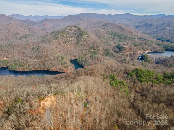 a view of a lush green hillside and a building