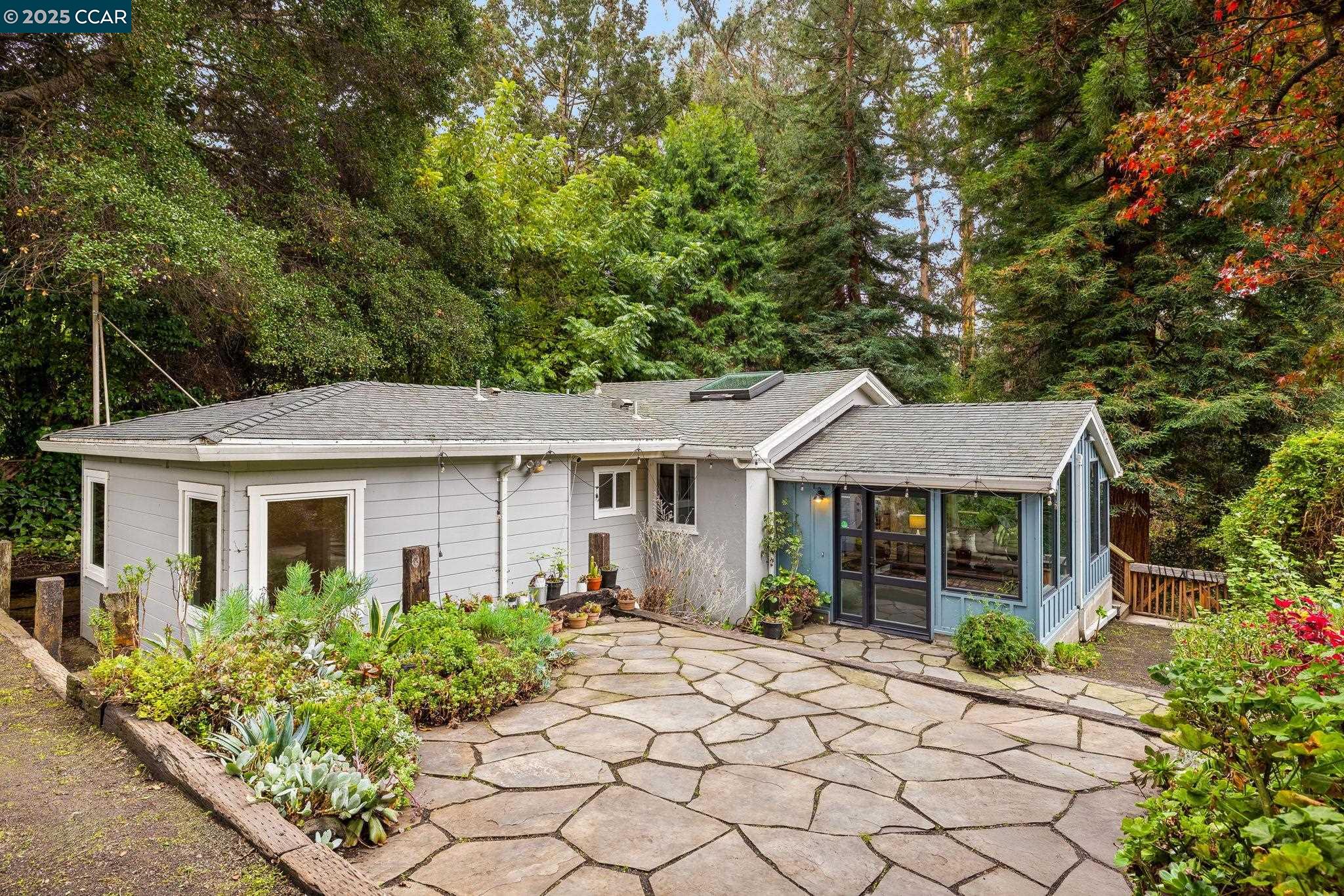 a front view of a house with a garden