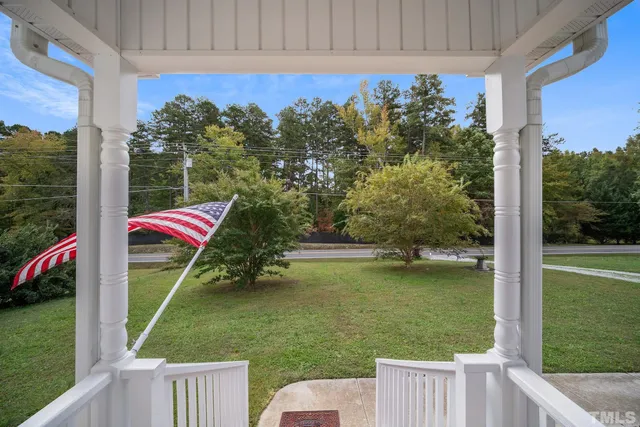 a view of a wooden deck with a yard