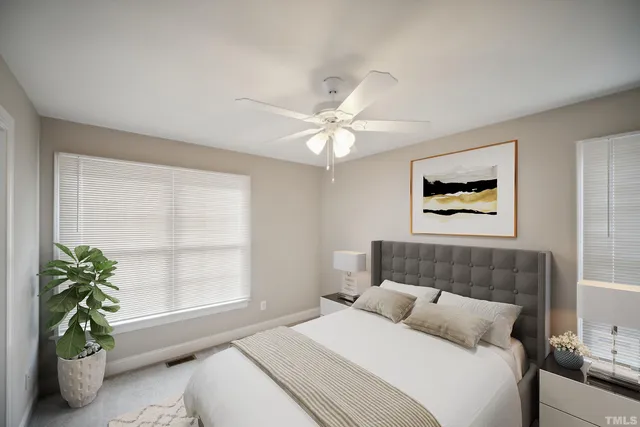 an empty room with windows and chandelier fan