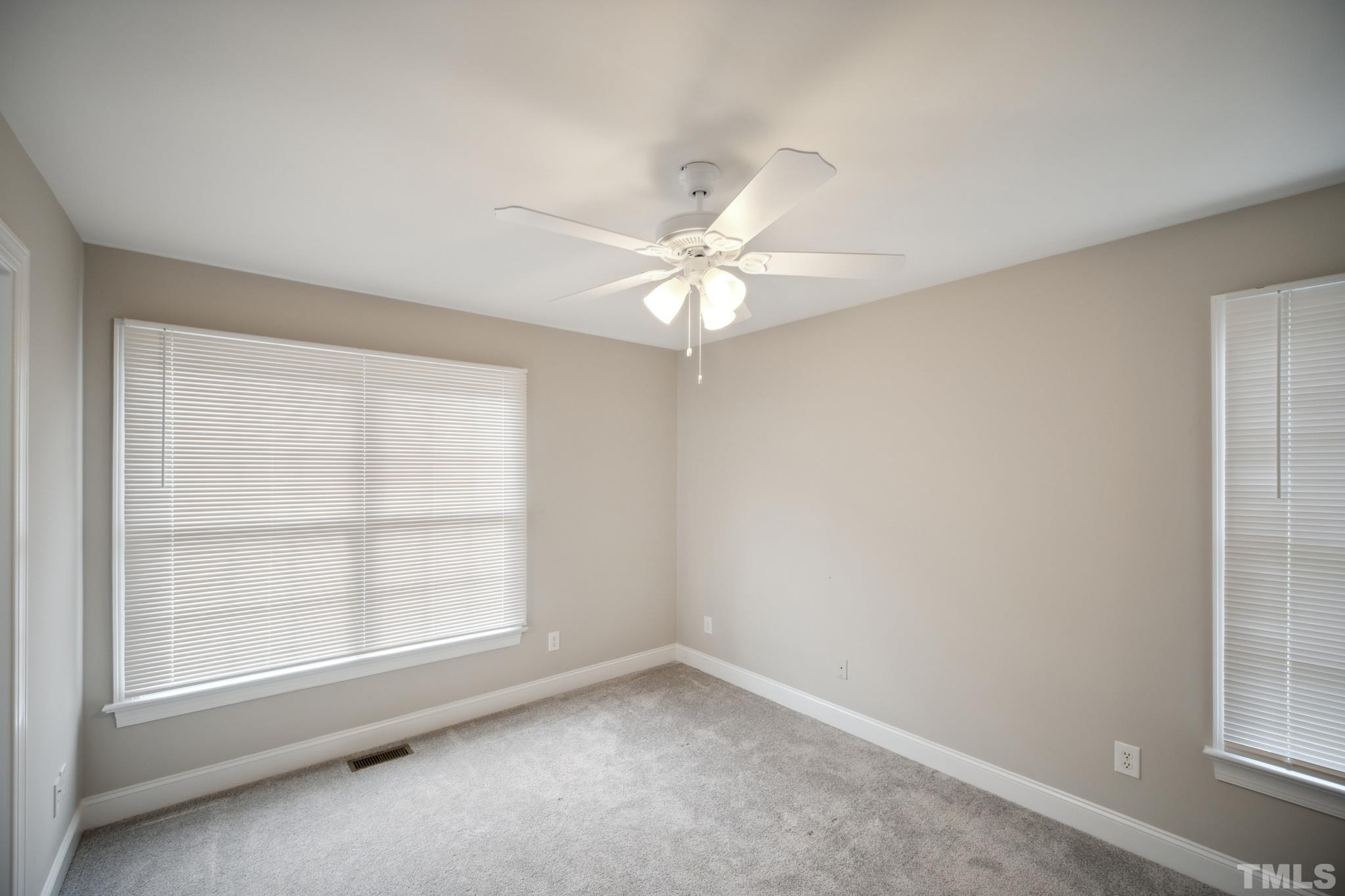 2131 Antioch Church Road Roxboro, NC 27574 - Photo 15 of 26 an empty room with windows and chandelier fan