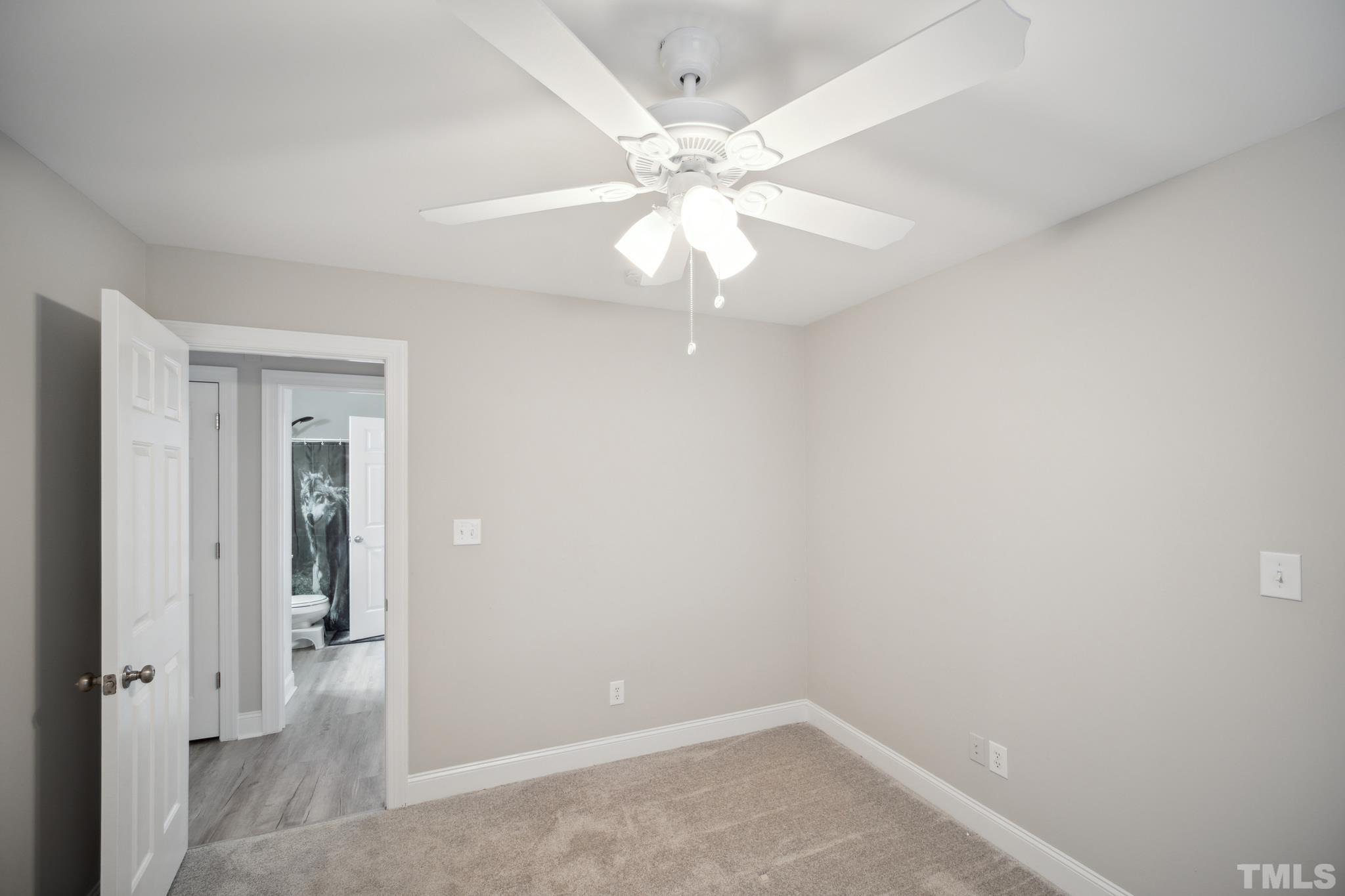 2131 Antioch Church Road Roxboro, NC 27574 - Photo 18 of 26 wooden floor in an empty room with a window
