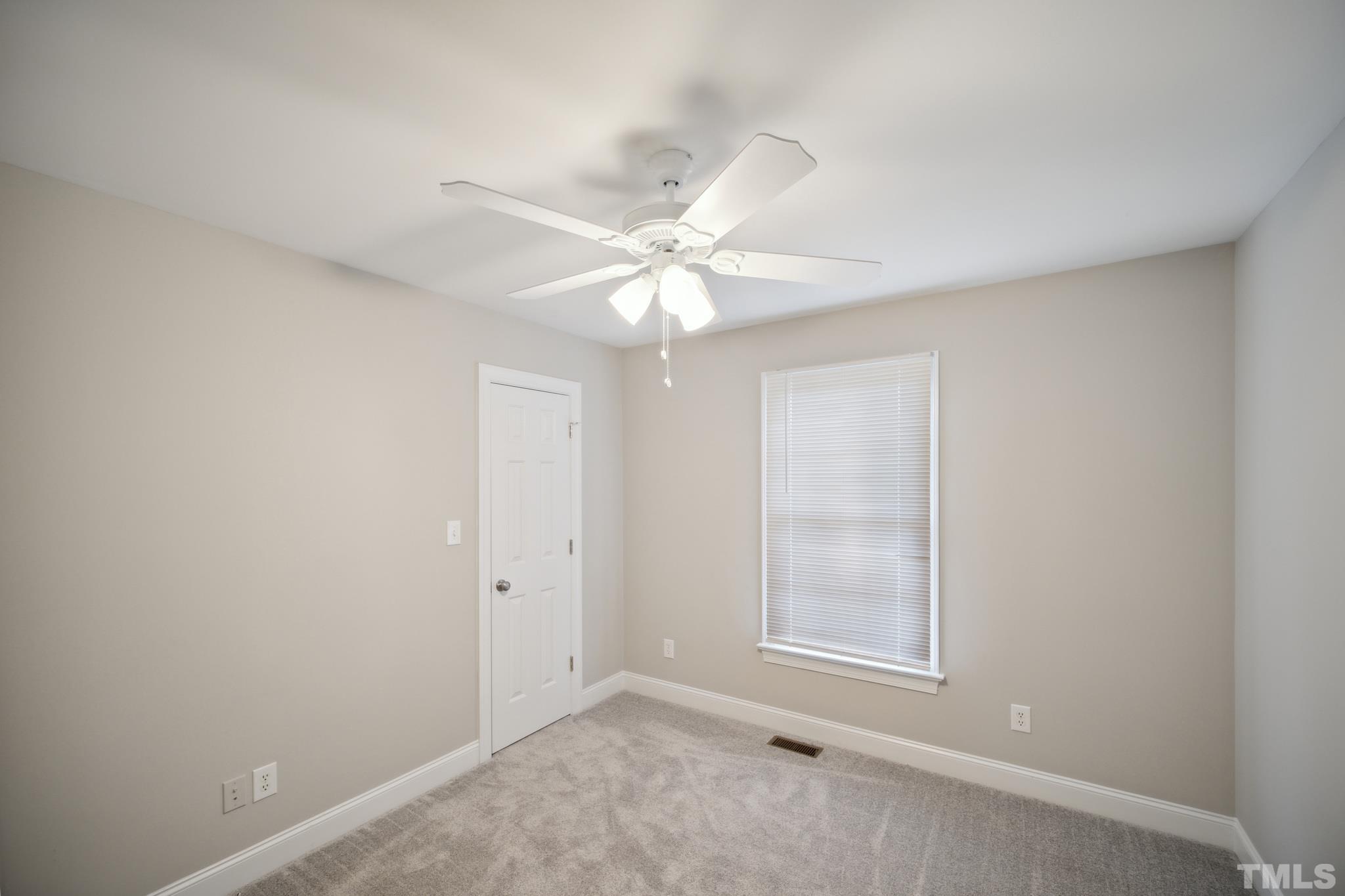 2131 Antioch Church Road Roxboro, NC 27574 - Photo 20 of 26 an empty room with windows and chandelier fan