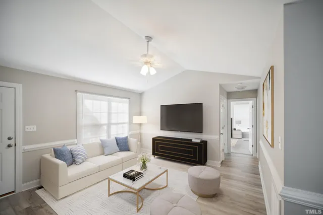 an empty room with wooden floor cabinet and windows