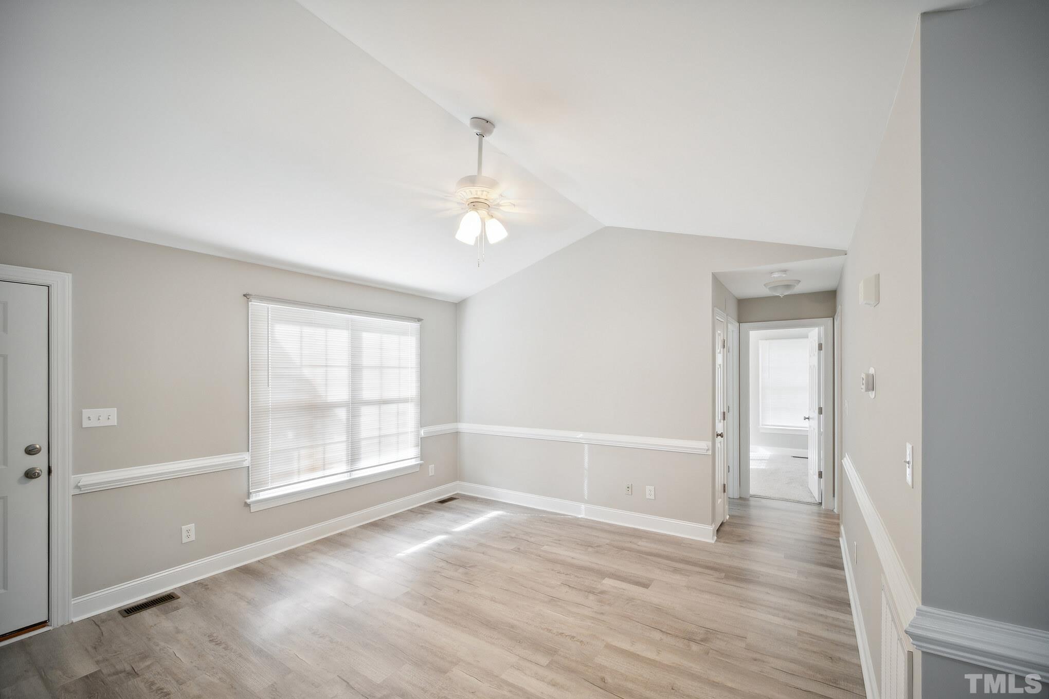 2131 Antioch Church Road Roxboro, NC 27574 - Photo 6 of 26 an empty room with wooden floor cabinet and windows