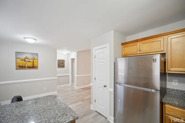a kitchen with granite countertop a sink a stove and cabinets